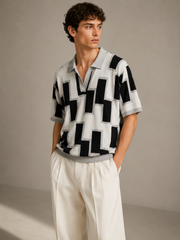 Men's ivory knit polo styled with cream wide-leg trousers — front model shot